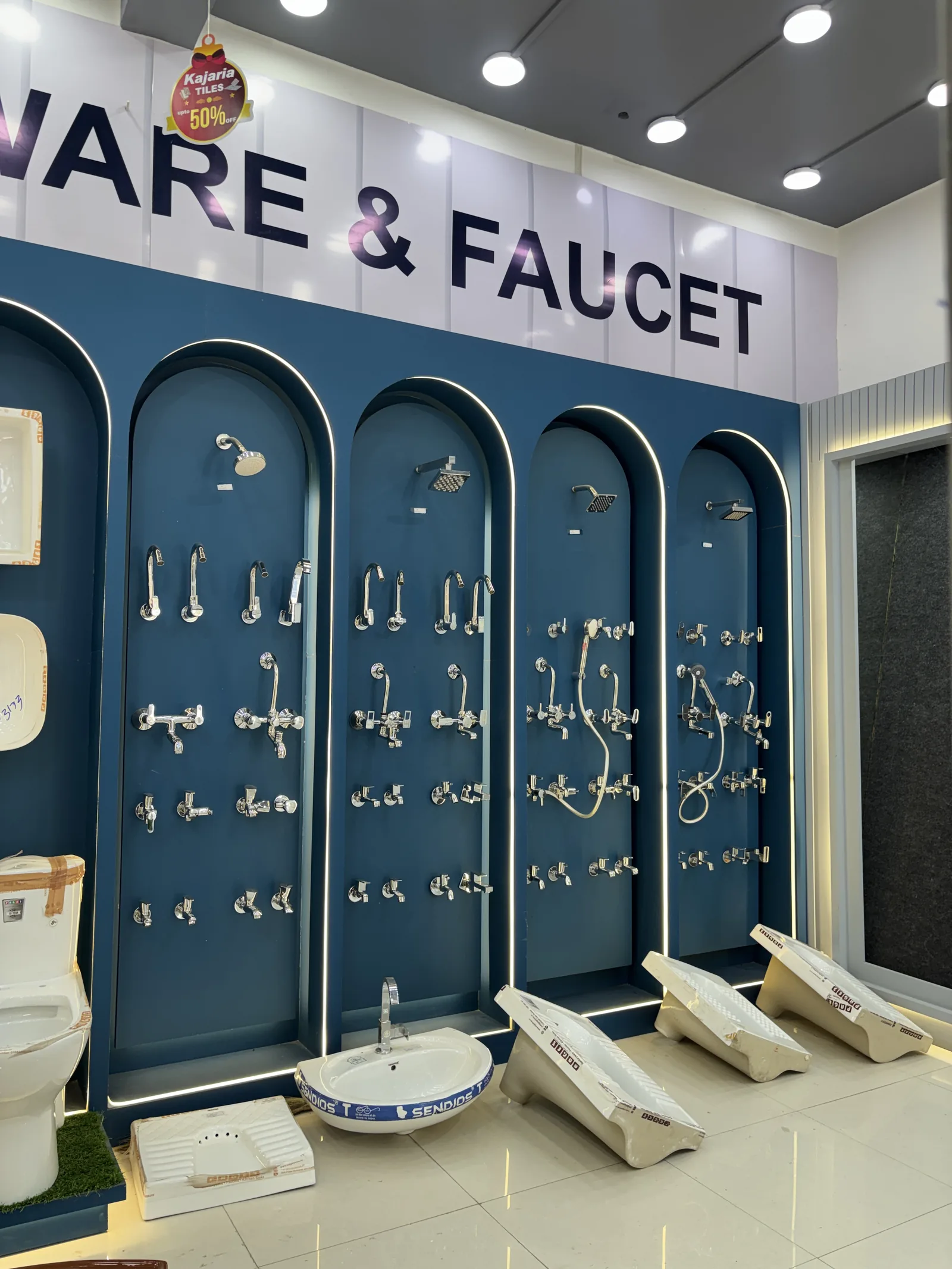 Chrome taps, mixers and bathroom fittings on the display wall at Balaji Mart, Bikapur