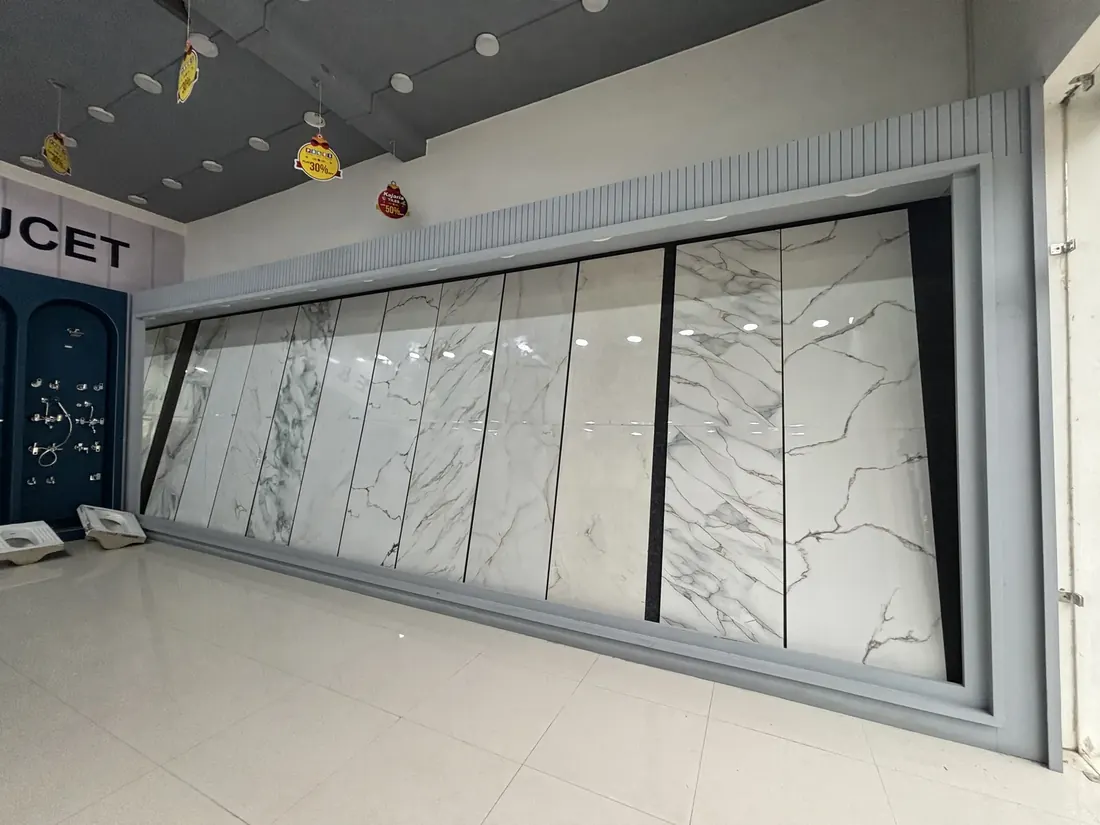 Large-format marble-effect floor tiles standing on the display wall at the Balaji Mart tiles showroom in Bikapur, Ayodhya