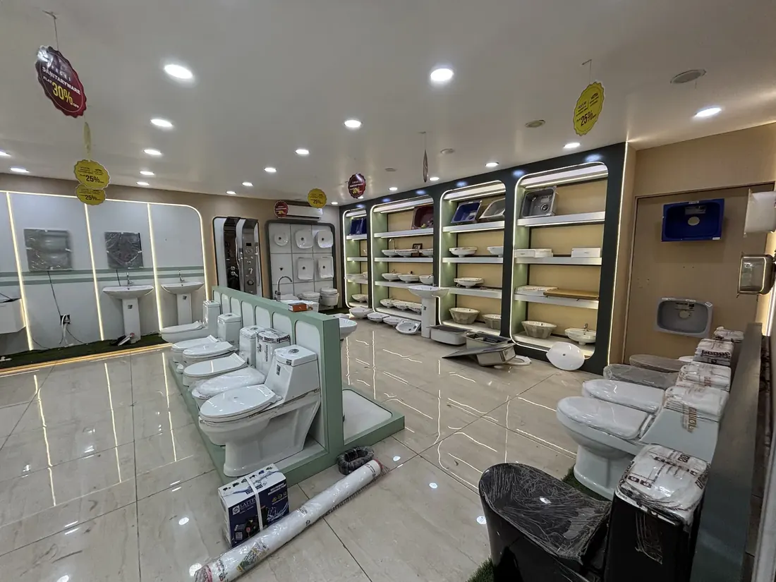 Wash basins and stainless steel kitchen sinks on the display wall at the Balaji Mart showroom, Bikapur