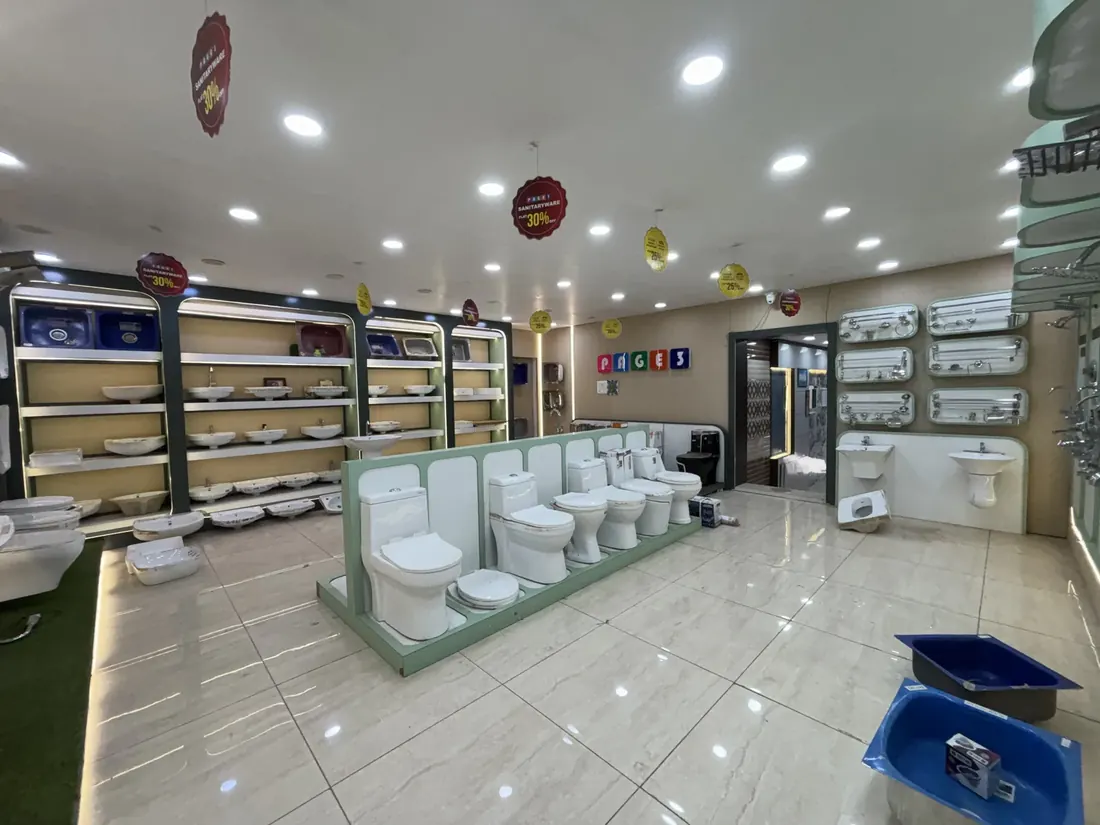 Western toilets and wash basins arranged across the sanitaryware showroom at Balaji Mart, Bikapur, Ayodhya